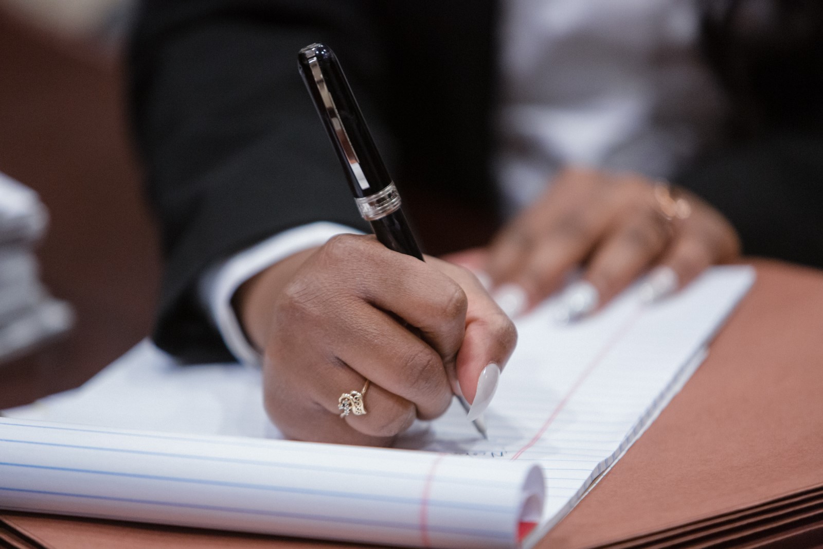 A Lawyer taking notes as she fine-tunes her arguments in court