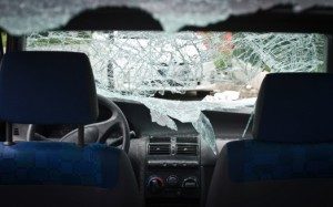 view into a vehicle after an accident, with the back window and front windshield shattered