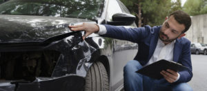 An agent inspecting a car crash 