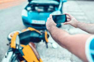 Male Photographing Car And Motorcycle Accident