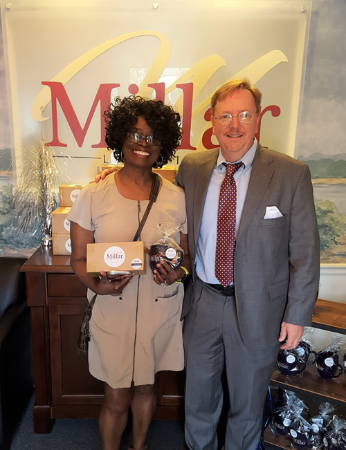Educator Maude Turnipseed poses with Bruce Millar for the Millar Law Firms pencils for clayton county schools initiative