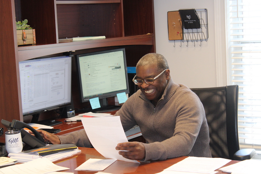 Paralegal smiling as he reviews a legal document