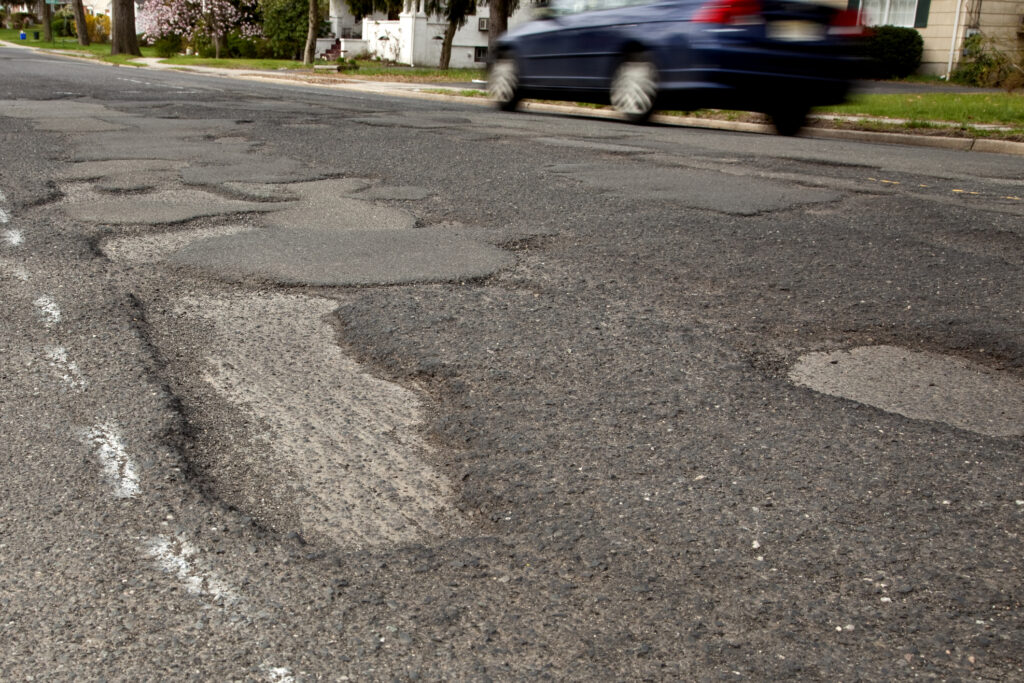 Severely potholed suburban road