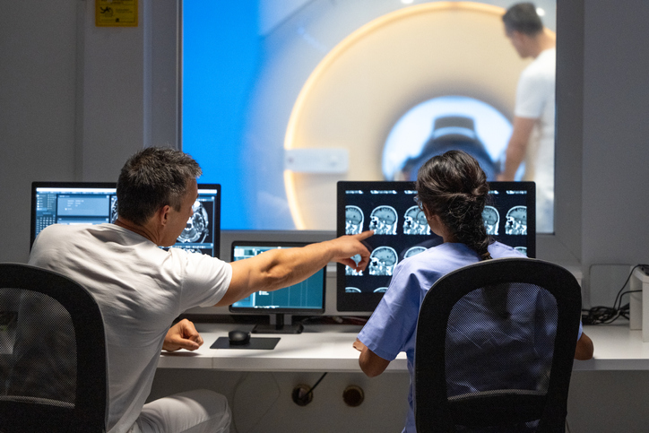 Two MRI radiologists sitting in the control room